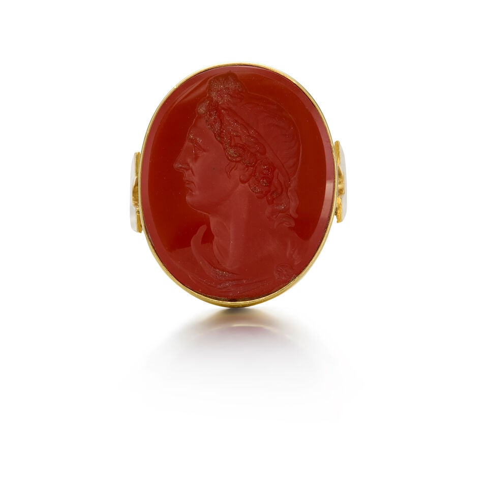 17K YELLOW GOLD AND CARNELIAN INTAGLIO RING: 17K YELLOW GOLD AND CARNELIAN INTAGLIO RING • One oval shaped carved carnelian measuring approximately 24.00mm x 19.87mm • Size 7 1/2 • Estimated gross weight: 14.6