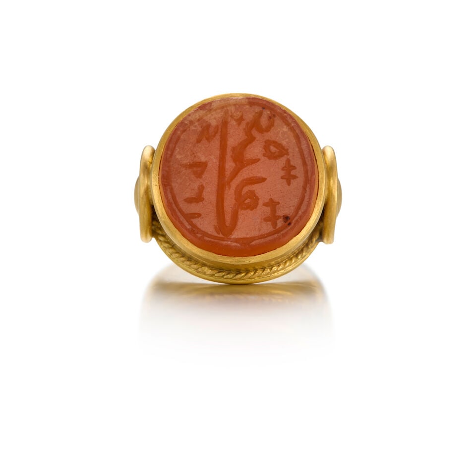 21K YELLOW GOLD AND CHALCEDONY RING: 21K YELLOW GOLD AND CHALCEDONY RING • One carved chalcedony tablet measuring approximately 15.43mm in diameter • Size 5 1/2 • Estimated gross weight: 12.6 grams Footnotes: OVERALL
