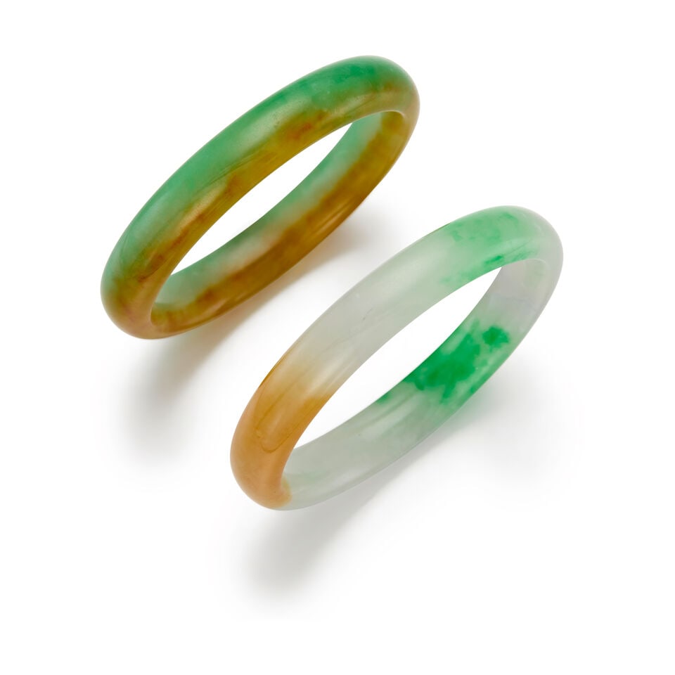 A SET OF JADE BANGLES: A SET OF JADE BANGLES • A jade bangle with inner circumference of 7 in. • A jade bangle with inner circumference of 7 1/2 in. • Estimated gross weight: 86.0 grams Footnotes: This
