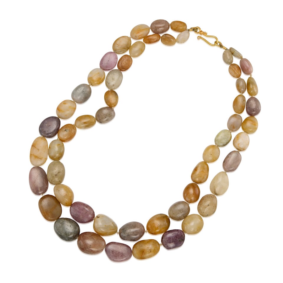 A GOLD AND MULTICOLOR GEMSTONE NECKLACE: A GOLD AND MULTICOLOR GEMSTONE NECKLACE • 14K and 19K gold • Numerous irregular-shaped multicolor gemstones measuring approximately 11.49mm x 8.51mm x 6.88mm to 20.03mm x 16.06mm x 11.13mm