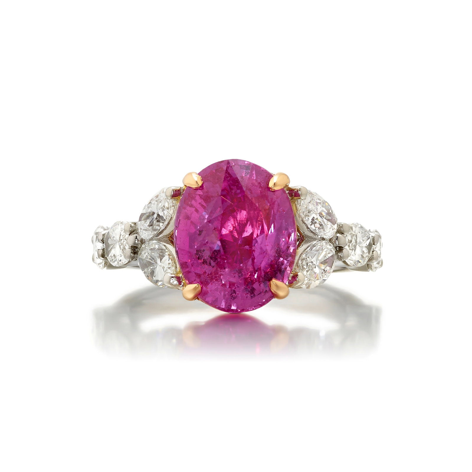 A PINK SAPPHIRE AND DIAMOND RING: A PINK SAPPHIRE AND DIAMOND RING Centering an oval-shaped pink sapphire weighing 6.05 carats, flanked by marquise-shaped diamonds; estimated total diamond weight 2.00 carats; mounted and fabricated in