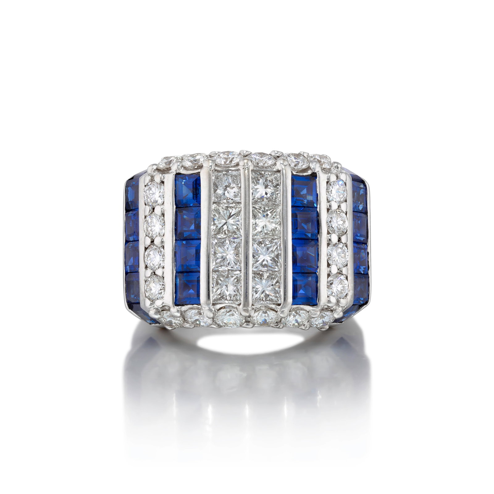 AN 18K WHITE GOLD, DIAMOND AND SAPPHIRE RING: AN 18K WHITE GOLD, DIAMOND AND SAPPHIRE RING Alternating rows of round and square brilliant-cut diamonds and square, step-cut sapphires; partial maker's mark and/or assay marks and/or serial numbers; 