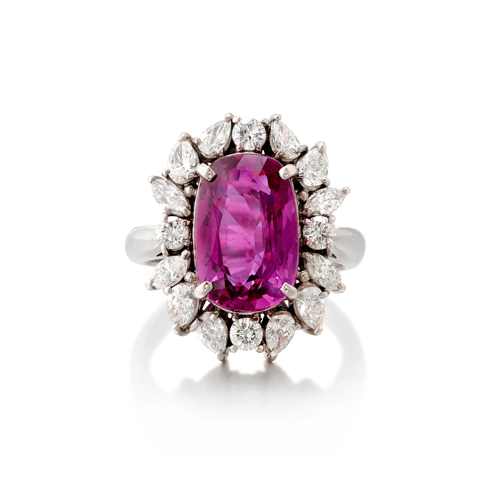 A PLATINUM, PURPLE SAPPHIRE AND DIAMOND RING: A PLATINUM, PURPLE SAPPHIRE AND DIAMOND RING Centering an elongated, modified cushion-shaped purple sapphire, in a surround of round brilliant-cut and pear-shaped diamonds; estimated sapphire weight 7
