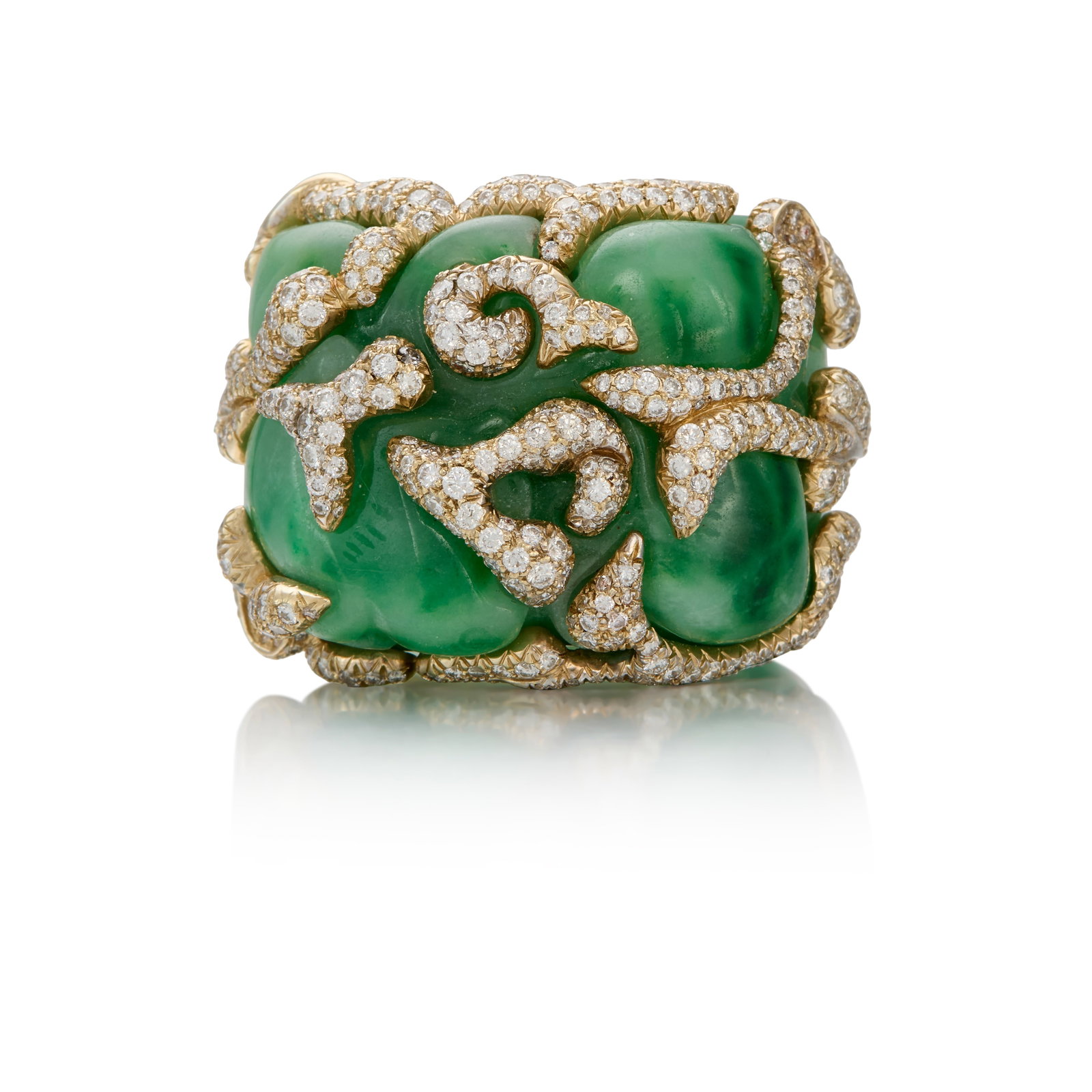 TONY DUQUETTE: A JADE AND DIAMOND RING: TONY DUQUETTE: A JADE AND DIAMOND RING Comprising a carved jade ring, accented throughout with pavé-set, round brilliant-cut diamonds; signed Tony Duquette; estimated total diamond weight 4.00