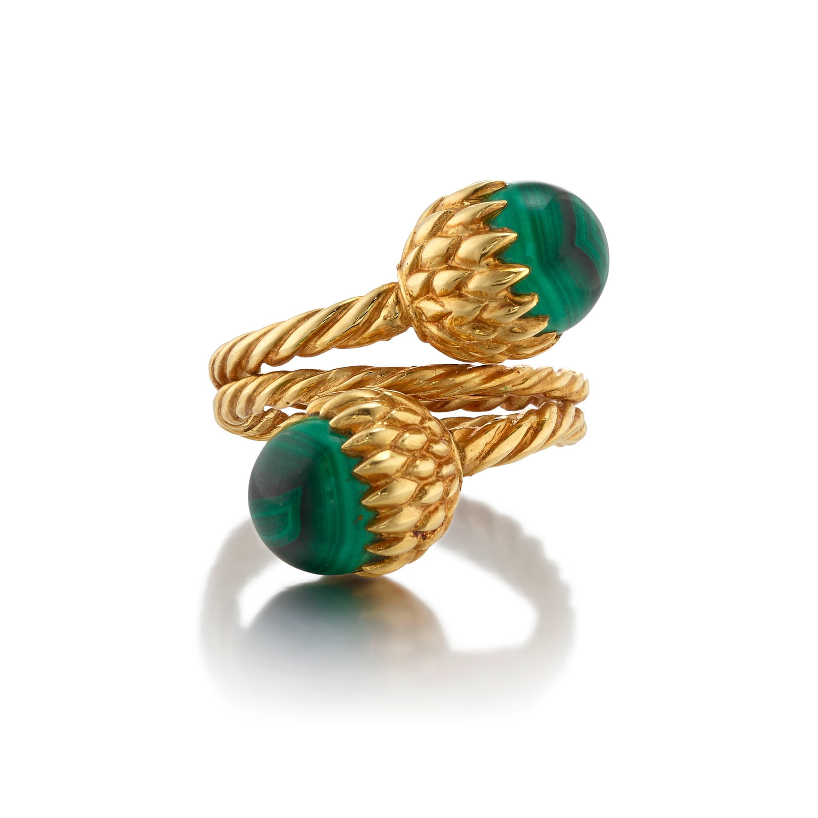 SCHLUMBERGER FOR TIFFANY & CO.: AN 18K GOLD AND MALACHITE 'ACORN' RING, CIRCA 1965: SCHLUMBERGER FOR TIFFANY & CO.: AN 18K GOLD AND MALACHITE 'ACORN' RING, CIRCA 1965 Of bypass design, comprising a spiraling gold rope with malachite terminals; signed Schlumberger; signed Tiffany; siz