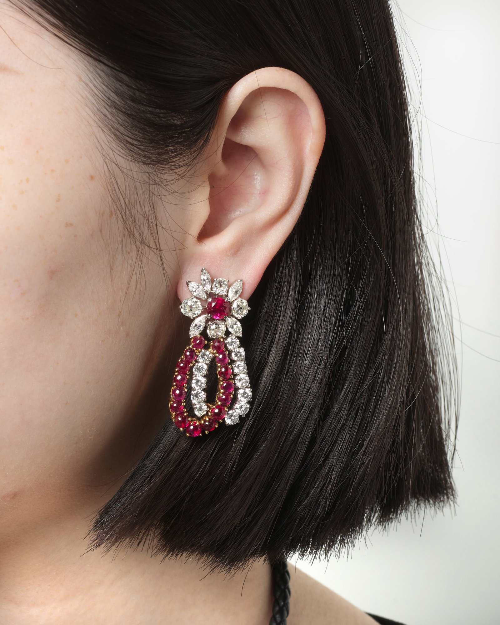 A PAIR OF DIAMOND AND RUBY EARRINGS: A PAIR OF DIAMOND AND RUBY EARRINGS Each comprising flower-inspired surmounts accented with cushion-shaped rubies and old mine-cut and marquise-shaped diamonds, suspending round brilliant-cut diamond