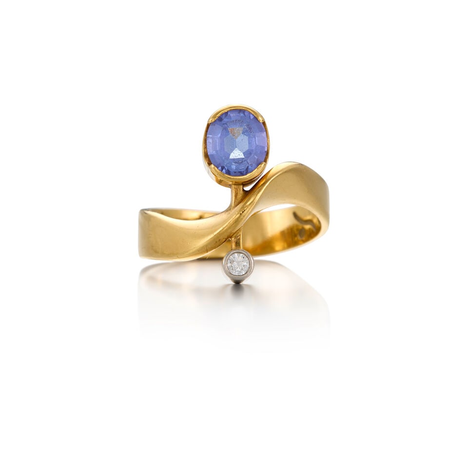 TANZANITE AND DIAMOND RING: TANZANITE AND DIAMOND RING • 18K yellow gold and white precious metal alloy composed primary of palladium with gold and minor silver content • One oval-shaped tanzanite weighing approximat