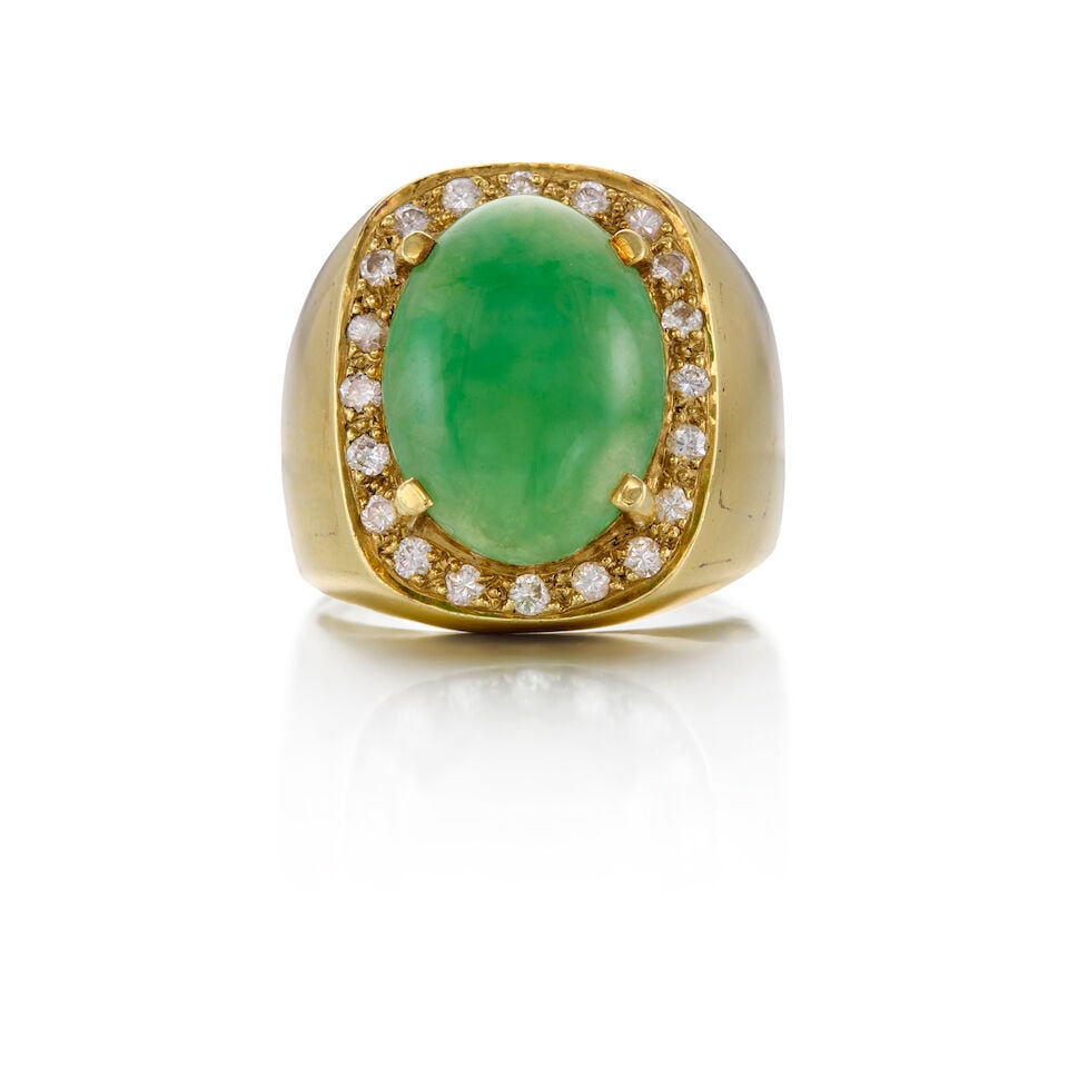14K YELLOW GOLD, JADE, AND DIAMOND RING: 14K YELLOW GOLD, JADE, AND DIAMOND RING • One jade cabochon measuring approximately 16.11mm x 12.13mm x 4.65mm • Twenty round brilliant cut diamonds weighing approximately 0.20 carat total