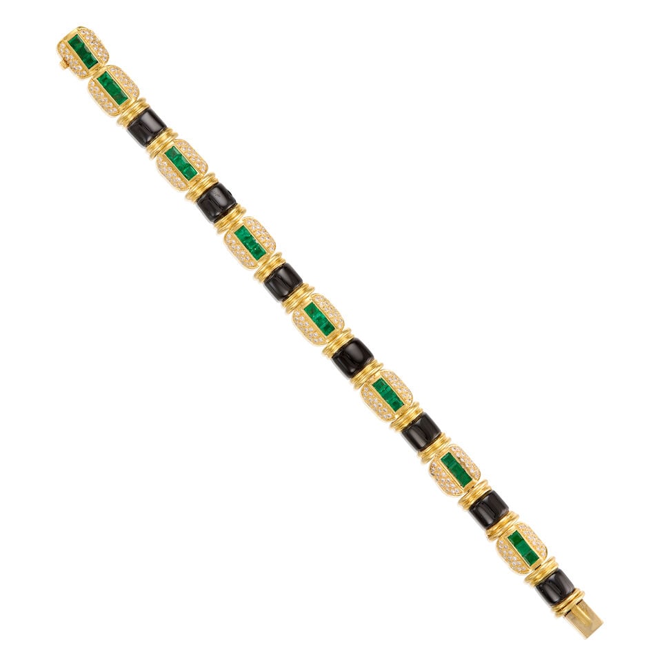 18K YELLOW GOLD, EMERALD, ONYX AND DIAMOND BRACELET: 18K YELLOW GOLD, EMERALD, ONYX AND DIAMOND BRACELET • Numerous square shaped and carved onyx measuring approximately 8.01mm x 6.68mm • Twenty-four square shaped emeralds weighing