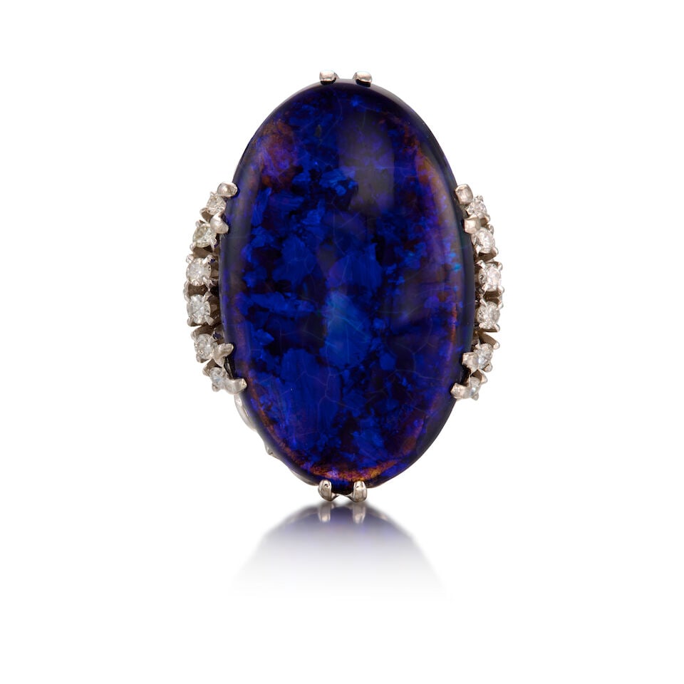 GOLD, BLACK OPAL, AND DIAMOND RING: GOLD, BLACK OPAL, AND DIAMOND RING • 18K and 14K white gold • One oval cabochon black opal measuring approximately 28.80mm x 17.60mm x 7.50mm • Twelve round brilliant cut diamonds we