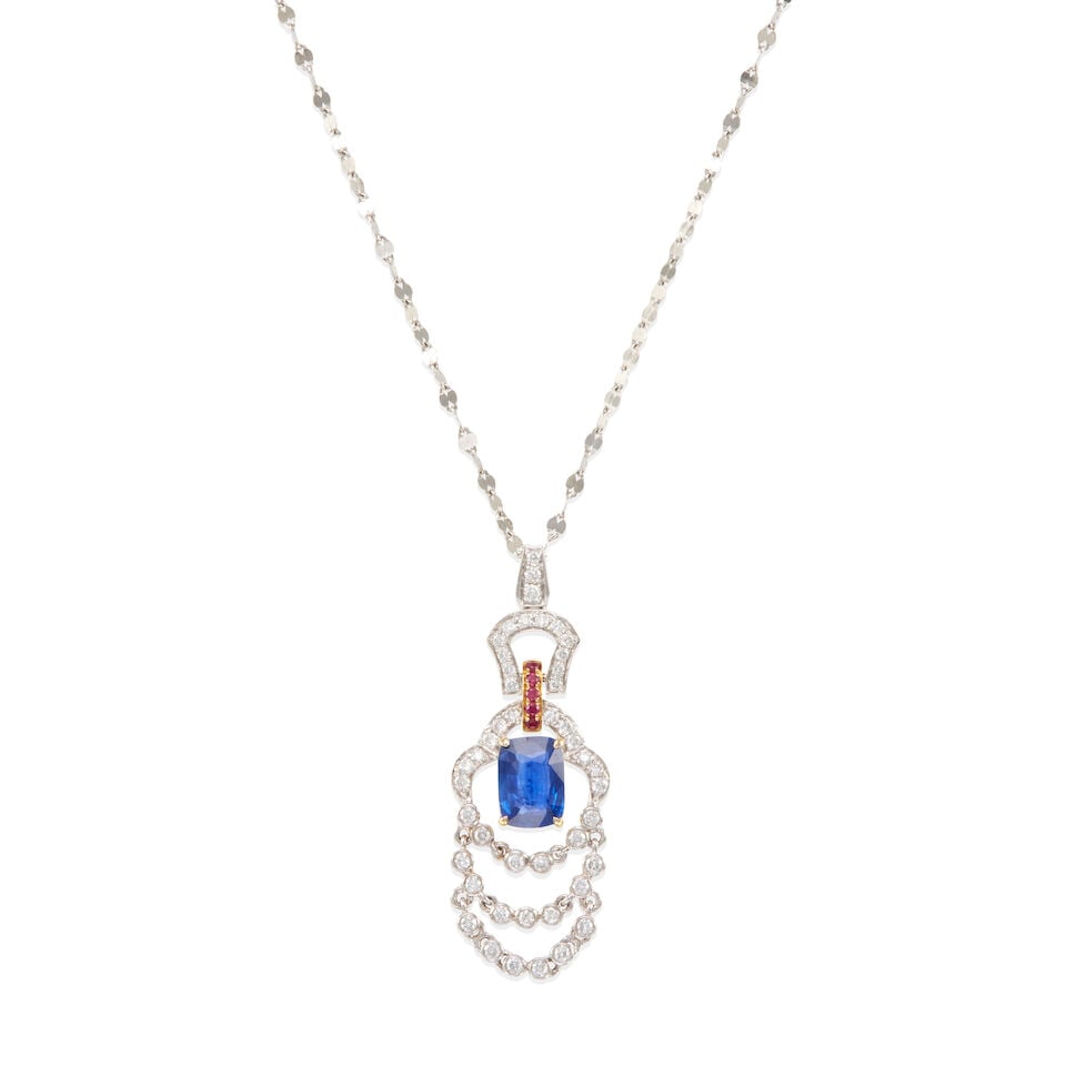 SAPPHIRE, RUBY AND DIAMOND PENDANT NECKLACE: SAPPHIRE, RUBY AND DIAMOND PENDANT NECKLACE • 18k white and yellow gold pendant with a platinum chain • Numerous round shaped diamonds weighing approximately 0.25 carat total • One