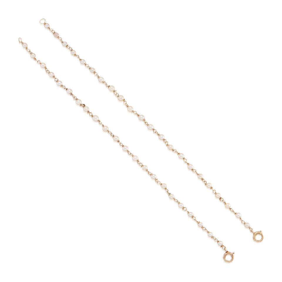 14K GOLD AND CULTURED PEARL BRACELETS: 14K GOLD AND CULTURED PEARL BRACELETS • A 14K yellow gold bracelet with twenty-two round drilled cultured pearl beads measuring approximately 3.14mm to 3.60mm in diameter, length 6 3/4 in. ̶