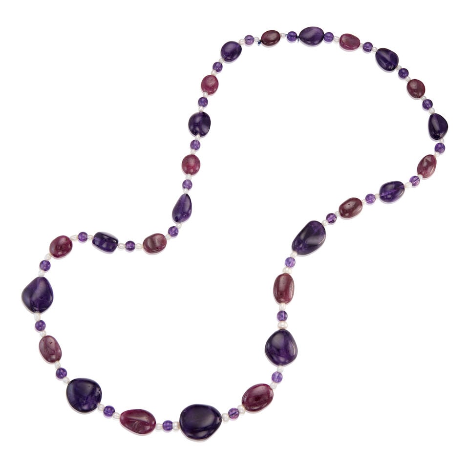 AMETHYST, RUBY AND CULTURED PEARL NECKLACE: AMETHYST, RUBY AND CULTURED PEARL NECKLACE • Numerous round, carved, and drilled amethysts in various shaped and sizes measuring approximately 6.12mm in diameter to 22.91mm x 20.27mm x 12.08mm &