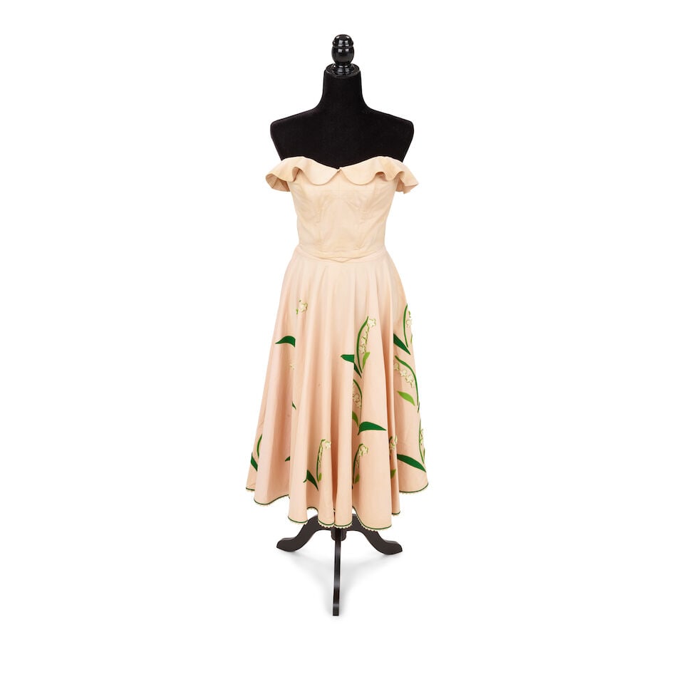TWO VINTAGE LOOKS Early 1980s, styled by Cyndi Lauper: TWO VINTAGE LOOKS Early 1980s, styled by Cyndi Lauper First look: a Juli Lynne Charlot pale peach strapless top and skirt with white and green floral decoration, and a shell bracelet; Second look: an