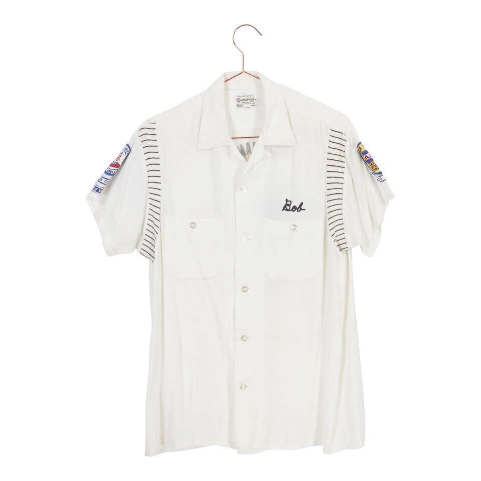 A GROUP OF VINTAGE AND BOWLING STYLE SHIRTS: A GROUP OF VINTAGE AND BOWLING STYLE SHIRTS Comprising a Marines Wives red button-up shirt inscribed Sue and a pair of green plaid pants, a Hilton men's black bowling shirt inscribed Jeanne, 38, an