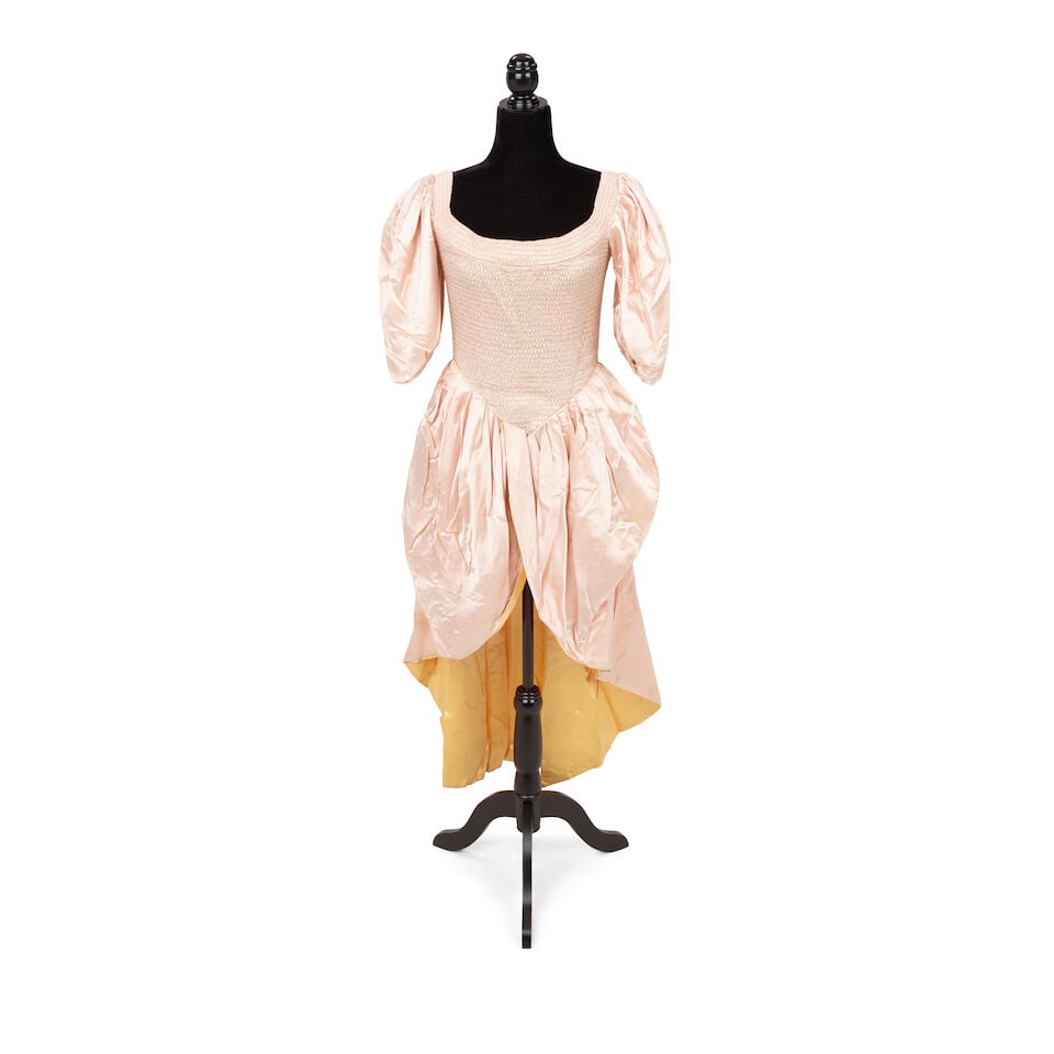 THREE STAGE-WORN DRESSES 1980s: THREE STAGE-WORN DRESSES 1980s Comprising a brown faux fur trimmed off-white silk strapless dress with pink piping and a bow with a red plaid cummerbund; a brown faux fur trimmed white polka dot 3/4 s