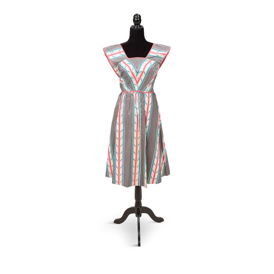 A GROUP OF BLUE ANGEL STAGE-WORN CLOTHING Early 1980s: A GROUP OF BLUE ANGEL STAGE-WORN CLOTHING Early 1980s Comprising a tropical print dress, a one-shoulder tropical print romper, a green button-up dress coat, a green dress, and a multicolored striped