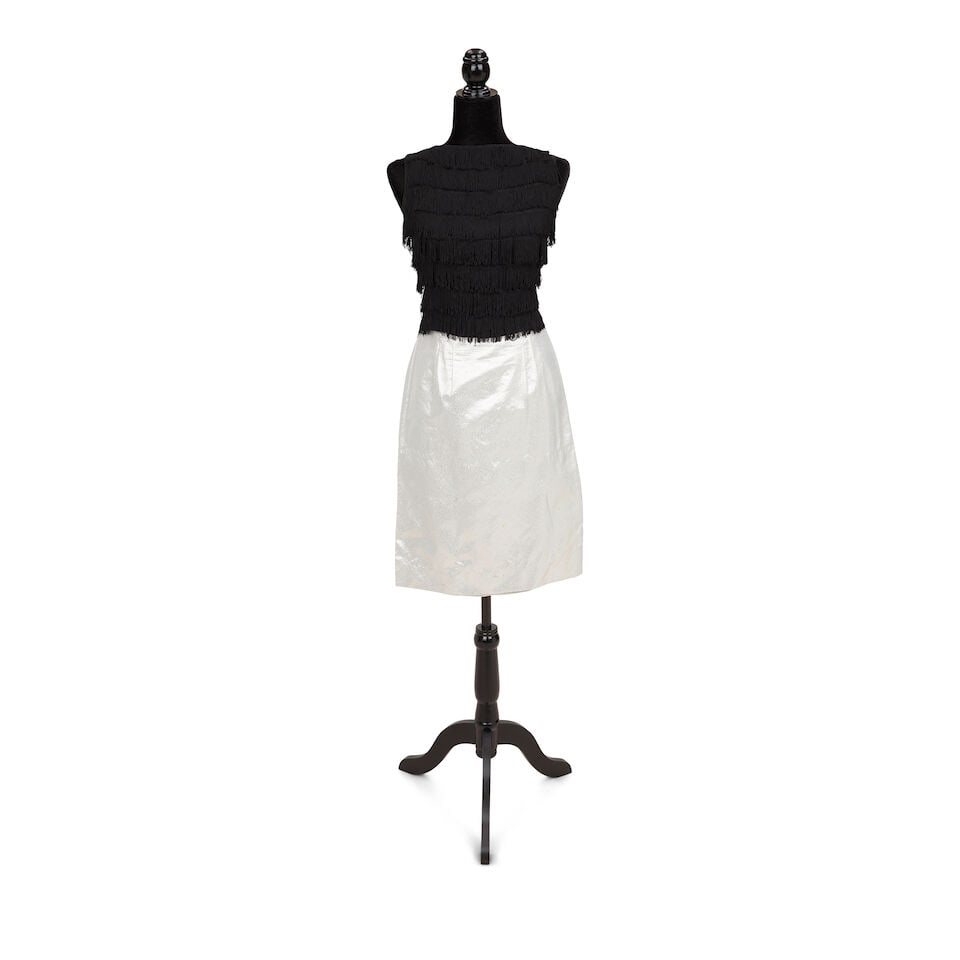 TWO LAYERED LOOKS Early 1980s, styled by Cyndi Lauper: TWO LAYERED LOOKS Early 1980s, styled by Cyndi Lauper First look: a Wrangler bleached denim vest 34, a black fringe top, and a silver skirt; Second look: a gray blue blazer and trousers and a black