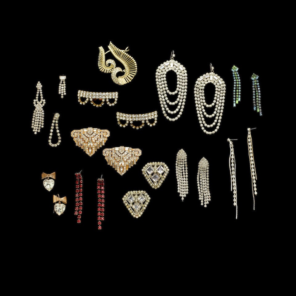 A GROUP OF STAGE-WORN VINTAGE COSTUME RHINESTONE EARRINGS AND ACCESSORIES 1980s: A GROUP OF STAGE-WORN VINTAGE COSTUME RHINESTONE EARRINGS AND ACCESSORIES 1980s Including a pair of heart and bow earrings, a colorless rhinestone and gold ear cuff, and three pairs of shoe