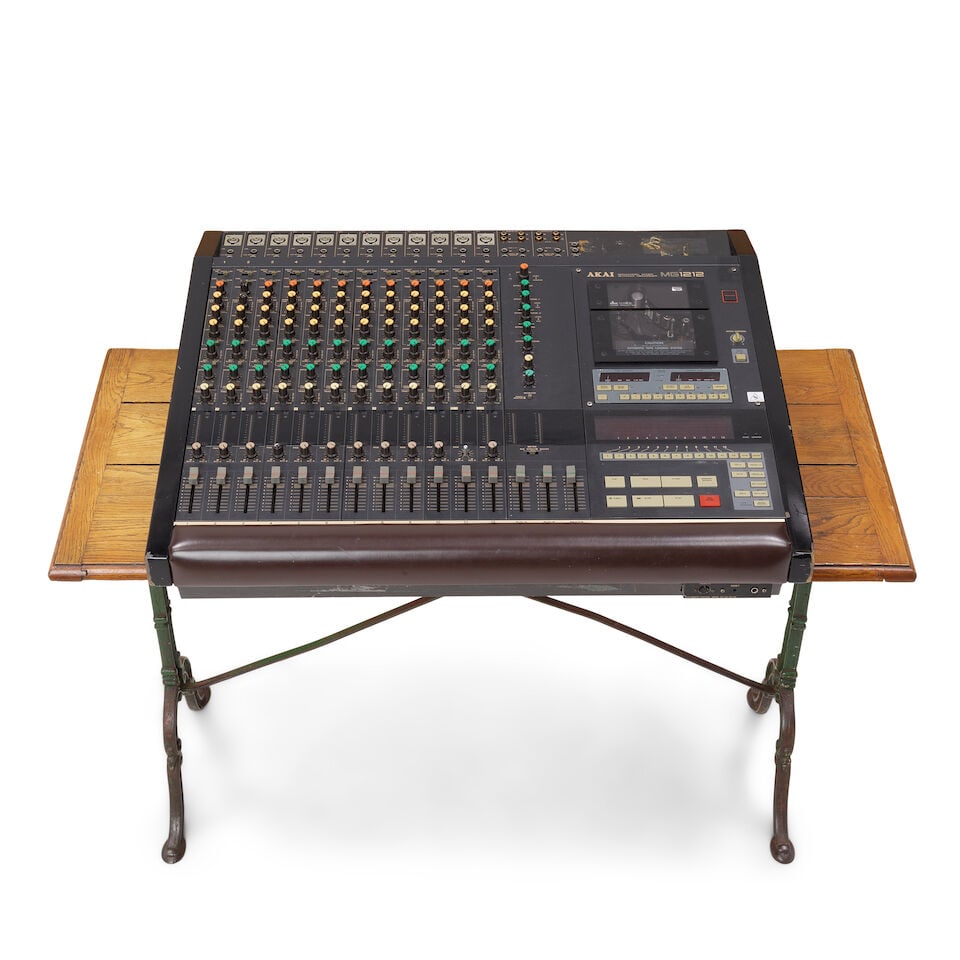 CYNDI LAUPER'S PERSONAL SOUND MIXING SET-UP: CYNDI LAUPER'S PERSONAL SOUND MIXING SET-UP Comprising an AKAI MG1212 12-channel mixer/12-track recorder and an iron mounted oak console table. (2) table 28 1/2 x 47 x 21 1/4in; equipment 7 x 33 3/4 x