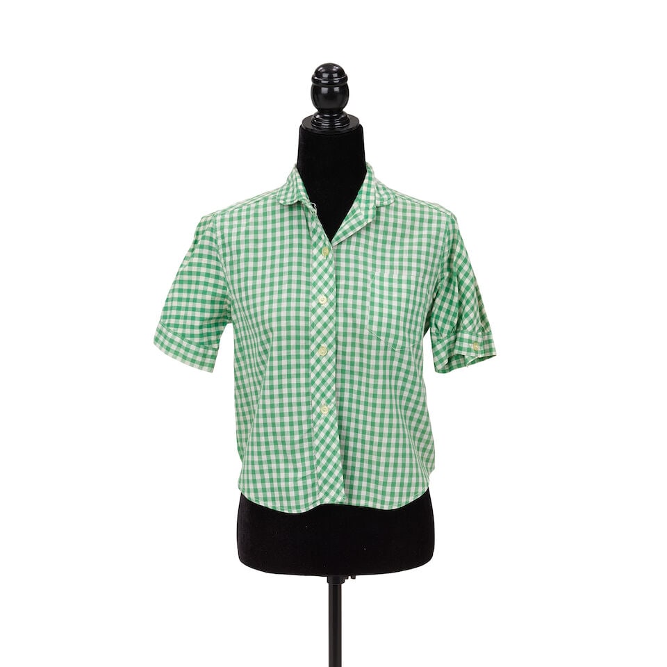 A GREEN GINGHAM SHIRT AND HAWAIIAN PRINT DRESS FROM 'THE GOONIES 'R GOOD ENOUGH' MUSIC VIDEO 1985: A GREEN GINGHAM SHIRT AND HAWAIIAN PRINT DRESS FROM 'THE GOONIES 'R GOOD ENOUGH' MUSIC VIDEO 1985 Comprising a green gingham short-sleeve button-up shirt and a Hawaiian print strapless dress,