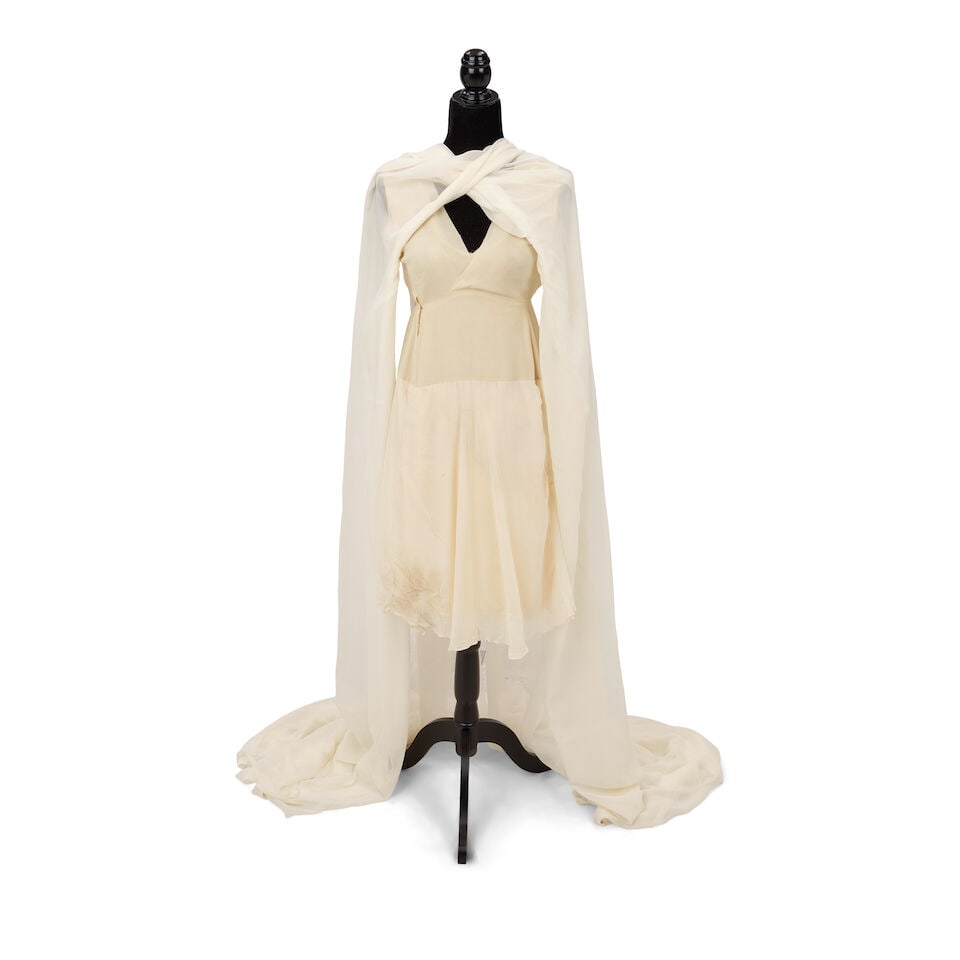 THE CHIFFON DRESS WORN IN THE 'TRUE COLORS' MUSIC VIDEO 1986: THE CHIFFON DRESS WORN IN THE 'TRUE COLORS' MUSIC VIDEO 1986 Together with extra crepe fabric. Footnotes: The dress and fabric also worn on the cover of the Boy Blue 1986 single. This lot is subject