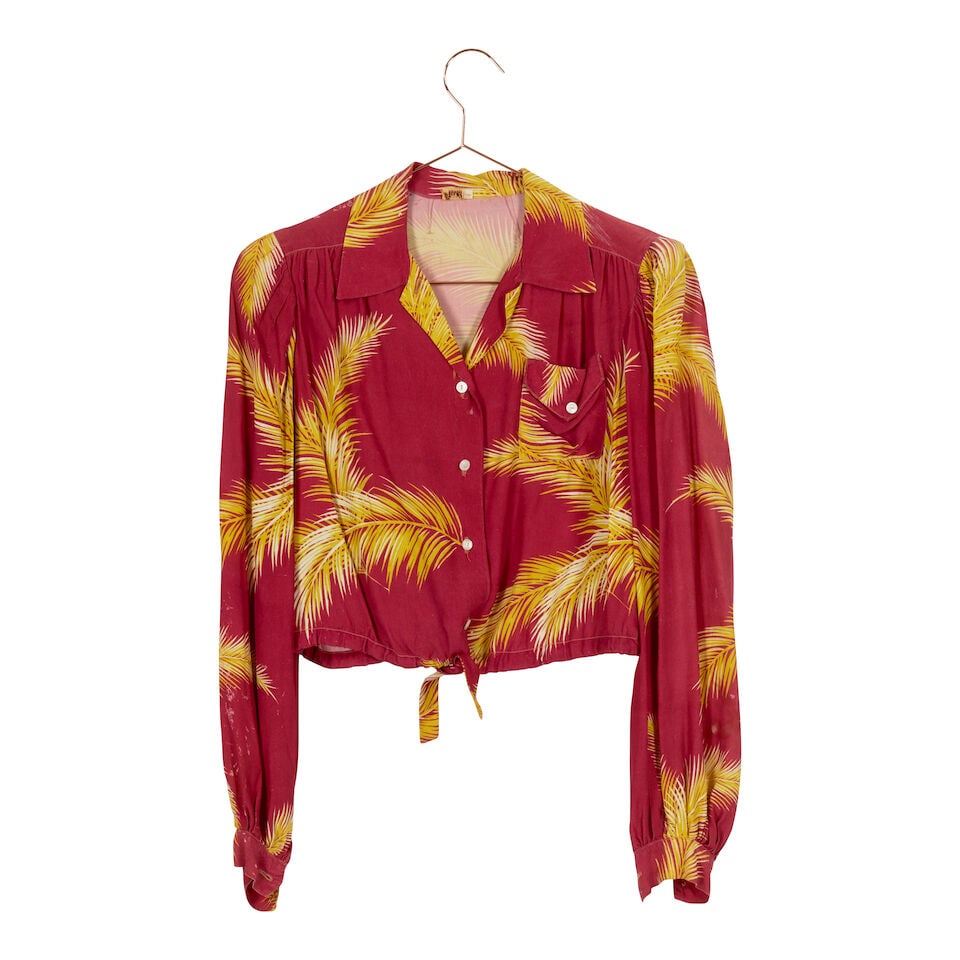 A GROUP OF CLOTHES WORN TO WWF EVENTS 1984-1986: A GROUP OF CLOTHES WORN TO WWF EVENTS 1984-1986 Comprising a red and yellow Hawaiian shirt and a white plastic and navy blue knit purse, a yellow and black polka dot bucket hat, a Samson's green men's