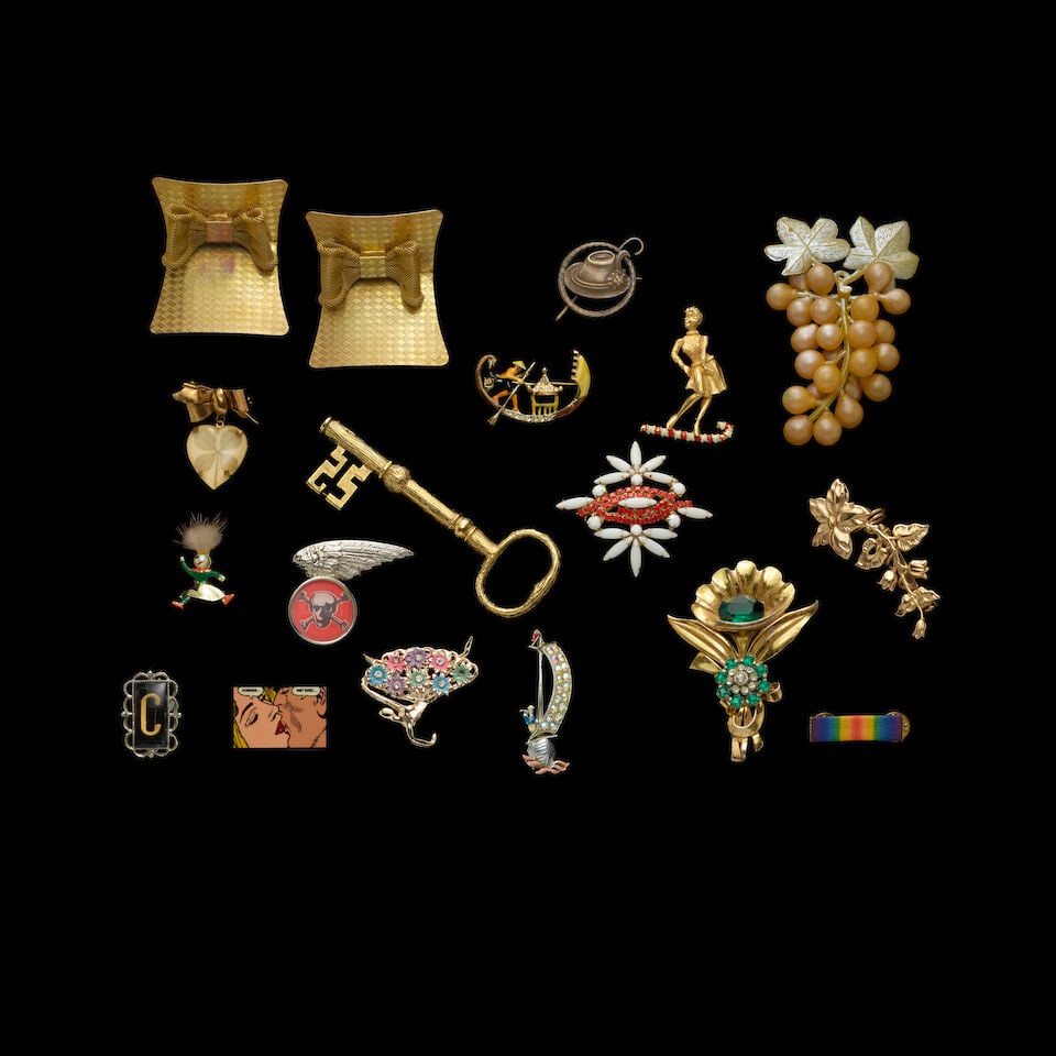A GROUP OF STAGE-WORN VINTAGE PINS AND SHOE BUCKLES 1980s: A GROUP OF STAGE-WORN VINTAGE PINS AND SHOE BUCKLES 1980s Including a pin with the letter C, a single white sequin and bead 'lips' shoe clip, and a large gold-tone key pin. Footnotes: The sequin