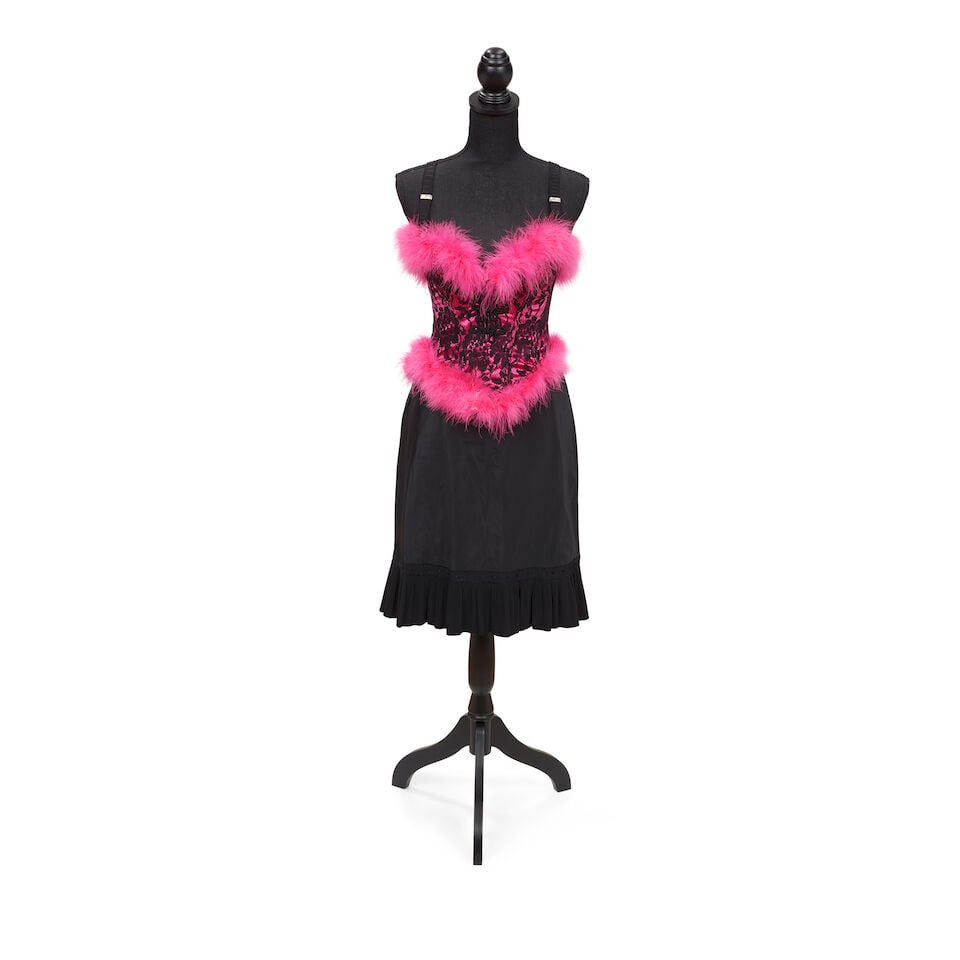 THREE TALK SHOW-WORN LOOKS Mid-late 1980s-early 1990s: THREE TALK SHOW-WORN LOOKS Mid-late 1980s-early 1990s First look: a pink and black lace feather trimmed corset, a black slip skirt, and a pair of black suspenders; Second look: a white lace