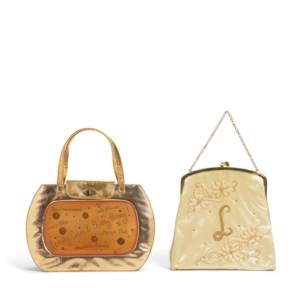 A GOLD METALLIC HANDBAG FROM THE TRUE COLORS WORLD TOUR 86-87 BOOK 1986: A GOLD METALLIC HANDBAG FROM THE TRUE COLORS WORLD TOUR 86-87 BOOK 1986 Comprising a 'Money Isn't Everything!' gold metallic and acrylic window handbag, together with a vintage gold embroidered plasti