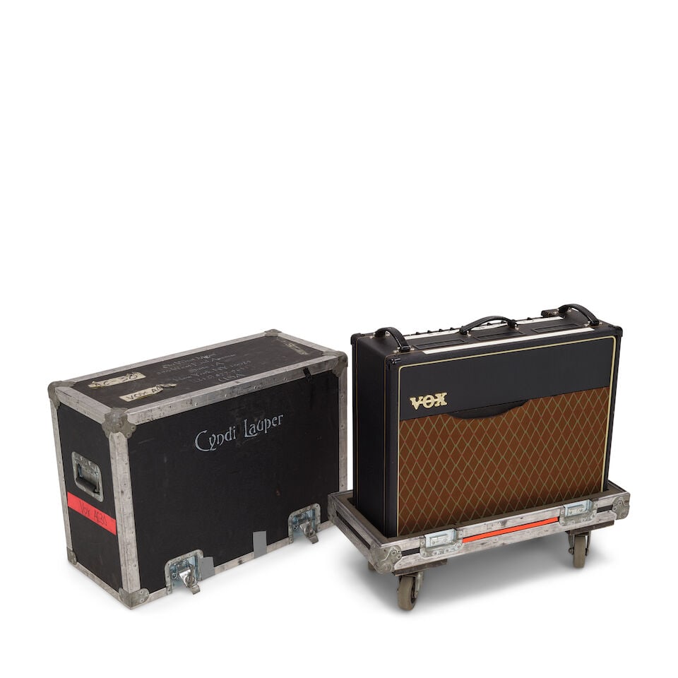 A TOUR-USED VOX BLUE COMBO AMPLIFIER IN A CYNDI LAUPER STENCILED WHEELED ROAD CASE: A TOUR-USED VOX BLUE COMBO AMPLIFIER IN A CYNDI LAUPER STENCILED WHEELED ROAD CASE Model AC30CC2X, serial no. X2AC00398, with a Vox VF002 dual footswitch pedal, the road case with various