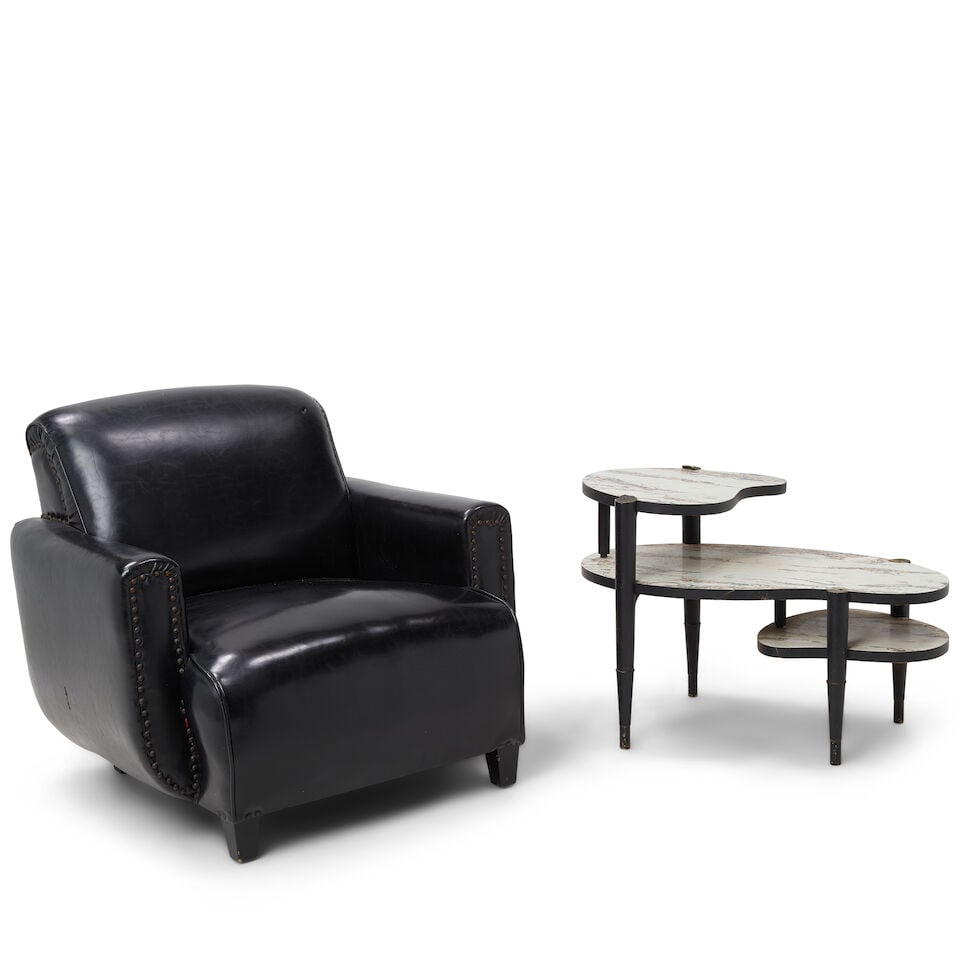 CYNDI LAUPER'S PERSONAL BLACK FAUX LEATHER ARMCHAIR AND FAUX MARBLE OCCASIONAL TABLE: CYNDI LAUPER'S PERSONAL BLACK FAUX LEATHER ARMCHAIR AND FAUX MARBLE OCCASIONAL TABLE chair 29 x 32 x 30in; table 21 1/4 x 31 1/2 x 18 1/2in This lot is subject to the following lot symbols: ¤ 