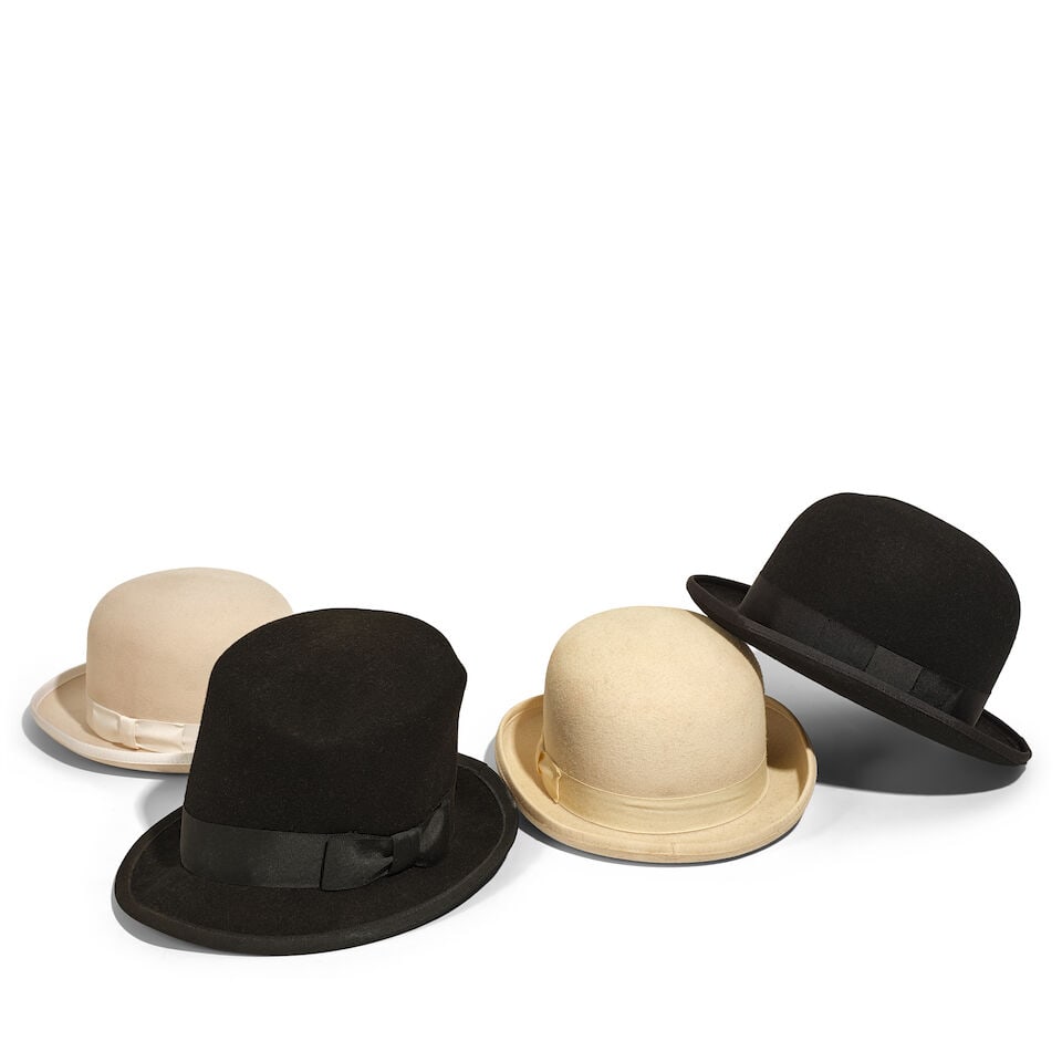 A BLACK FELT TOP HAT AND THREE FELT BOWLER HATS: A BLACK FELT TOP HAT AND THREE FELT BOWLER HATS Comprising a black top hat, a black bowler hat, and two cream bowler hats. (4) This lot is subject to the following lot symbols: ¤ ¤ Unless