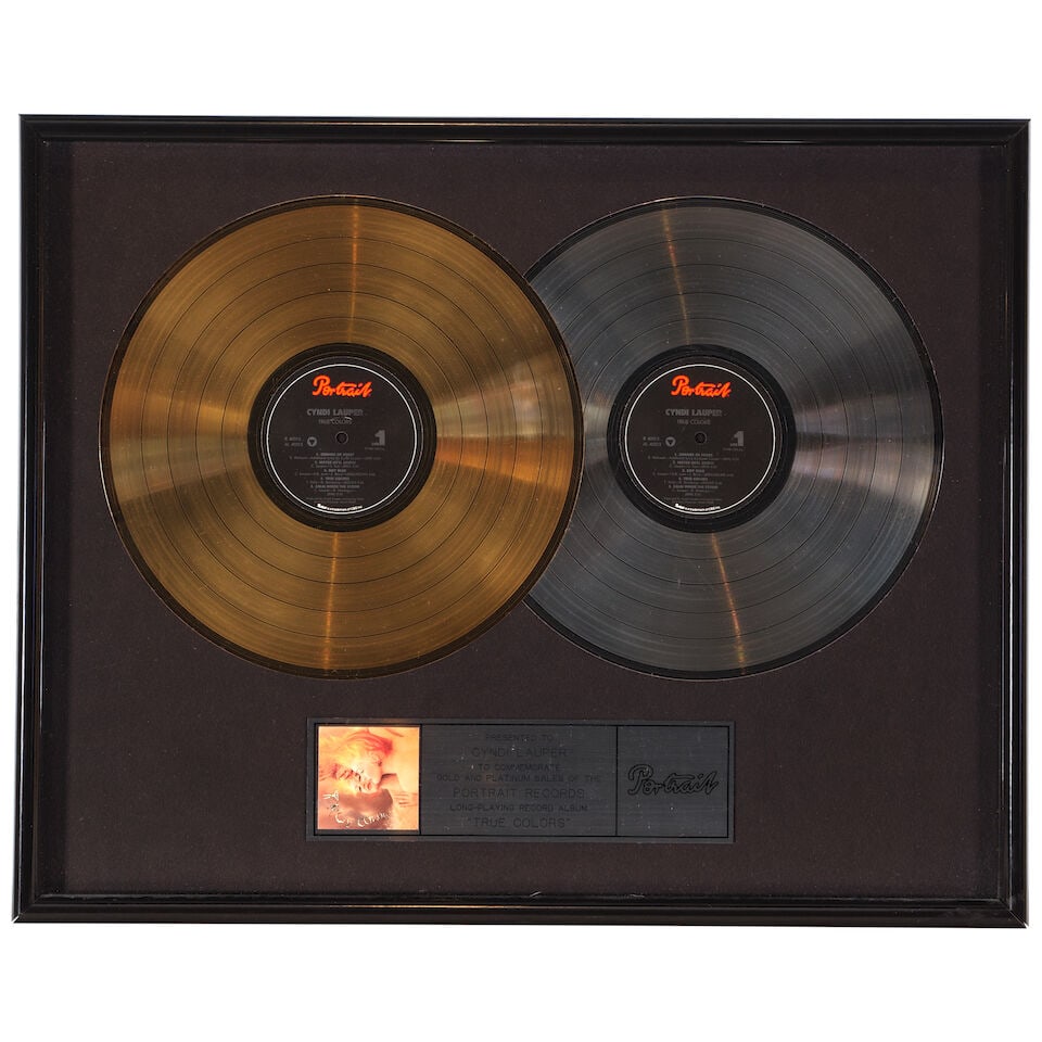 THREE FRAMED AWARDS FOR TRUE COLORS PRESENTED TO CYNDI LAUPER 1986: THREE FRAMED AWARDS FOR TRUE COLORS PRESENTED TO CYNDI LAUPER 1986 Comprising two RIAA Platinum Portrait Record Album and Cassette Awards and a Long-Playing Record Album Award. frames 20 3/4 x 16 3/4