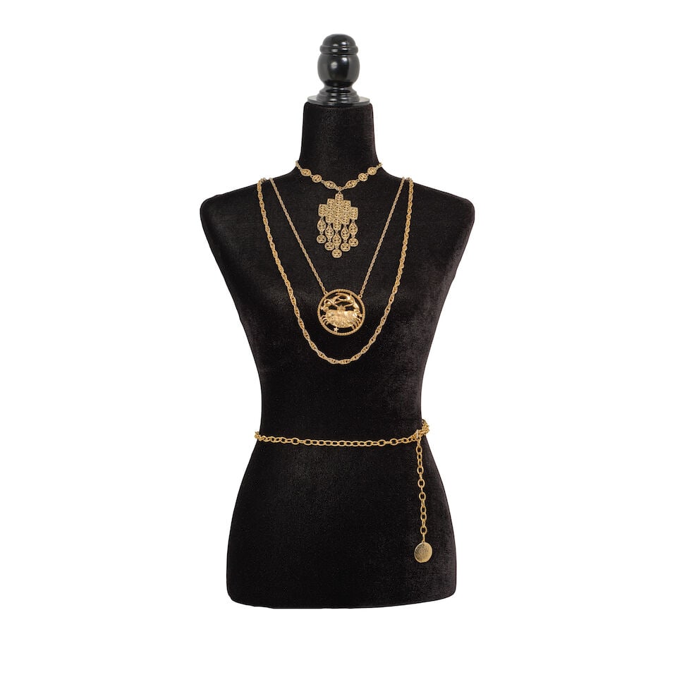 A GROUP OF STAGE-WORN VINTAGE COSTUME JEWELRY 1980s: A GROUP OF STAGE-WORN VINTAGE COSTUME JEWELRY 1980s Including a silvered metal chain hand necklace, a silver chain bolo tie with yellow-green rhinestone, and a gold cancer zodiac chain necklace. This