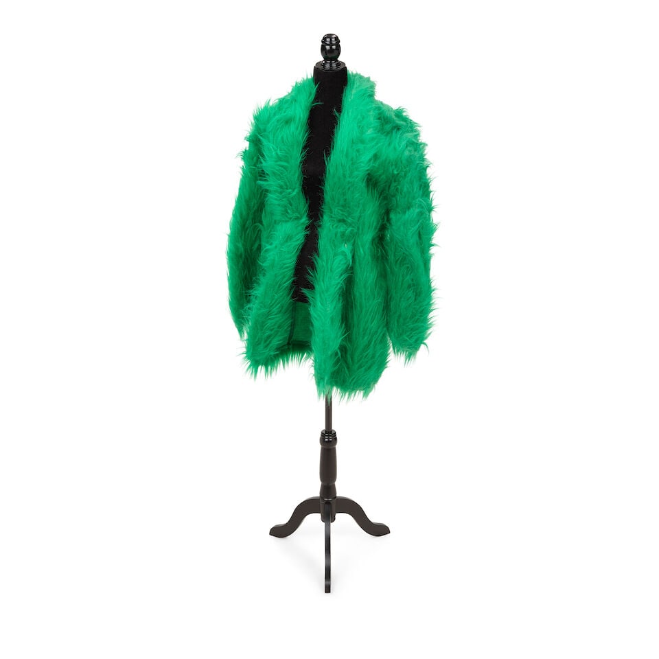 A GROUP OF CLOTHING WORN ONSTAGE AND IN PUBLIC APPEARANCES 1990s: A GROUP OF CLOTHING WORN ONSTAGE AND IN PUBLIC APPEARANCES 1990s Comprising a Katherine Hamnett London three-piece silver suit, a green faux fur coat, a Chinoiserie silk vest, a teal satin slip,