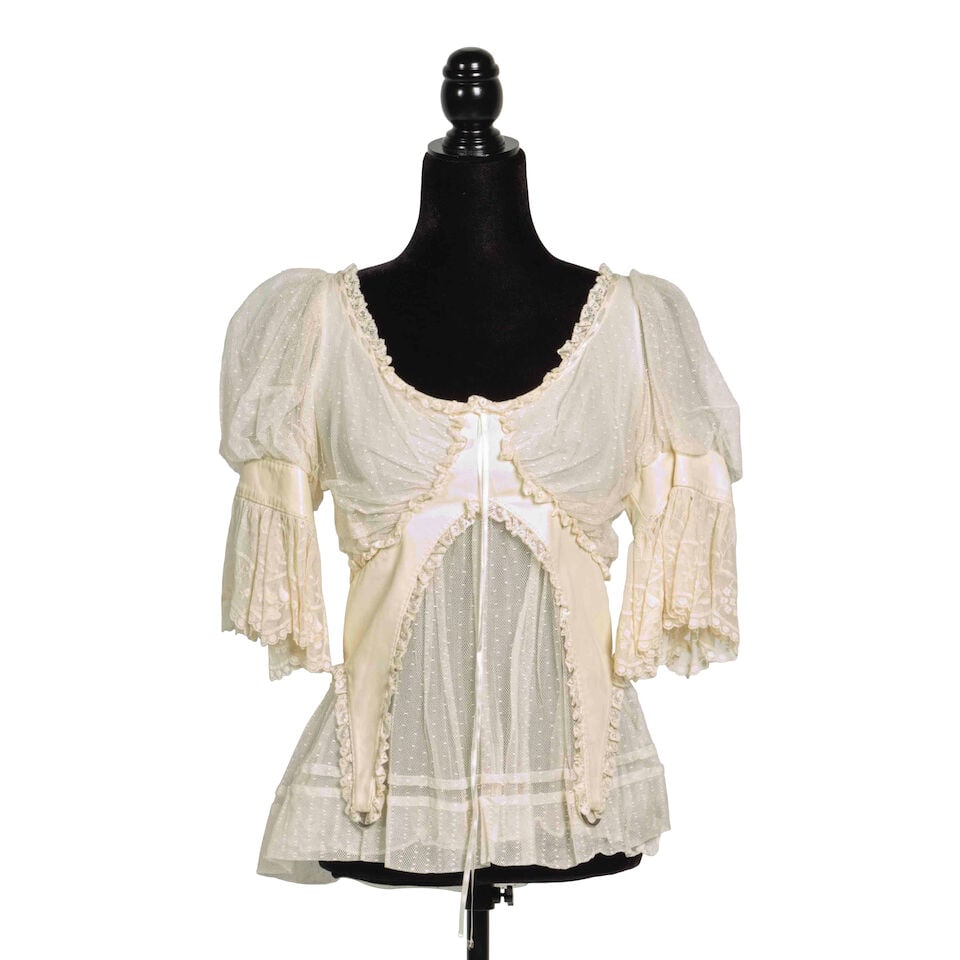 THREE ALEXANDER MCQUEEN BLOUSES Alexander McQueen, 2004-2005: THREE ALEXANDER MCQUEEN BLOUSES Alexander McQueen, 2004-2005 Comprising a plaid button-up cotton blouse from the 'Deliverance' Collection, Spring/Summer 2004, an off-white lace and leather ruffle