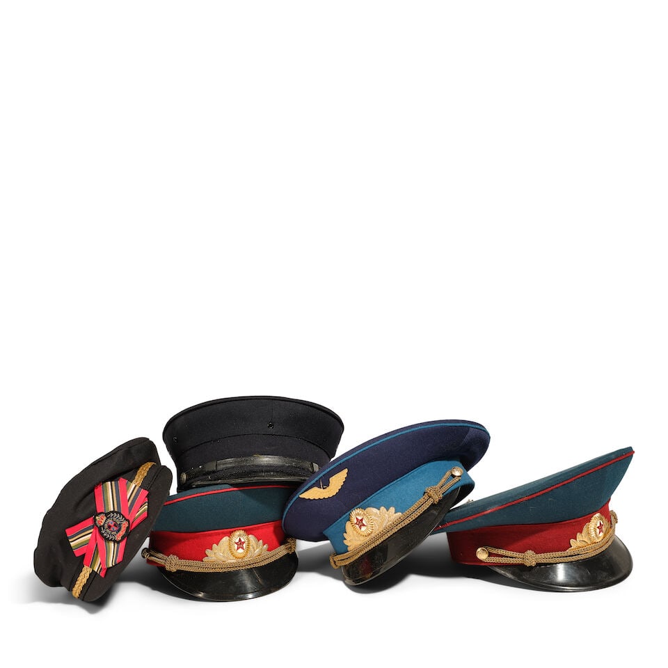 A GROUP OF MILITARY STYLE CAPS: A GROUP OF MILITARY STYLE CAPS Various styles and makers, including one Two City Girls hat. (5) interiors between approximately 7 x 7in and 8 x 7 1/2in This lot is subject to the following lot