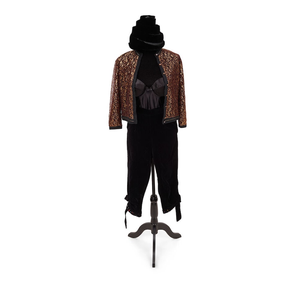 TWO BLACK AND GOLD LOOKS AND A LEOPARD PRINT RAINCOAT AND HAT 1980s, styled by Cyndi Lauper: TWO BLACK AND GOLD LOOKS AND A LEOPARD PRINT RAINCOAT AND HAT 1980s, styled by Cyndi Lauper First look: a Park-Storyk gold lace cardigan, a pair of black velvet pants with jeweled cuffs, 10, a