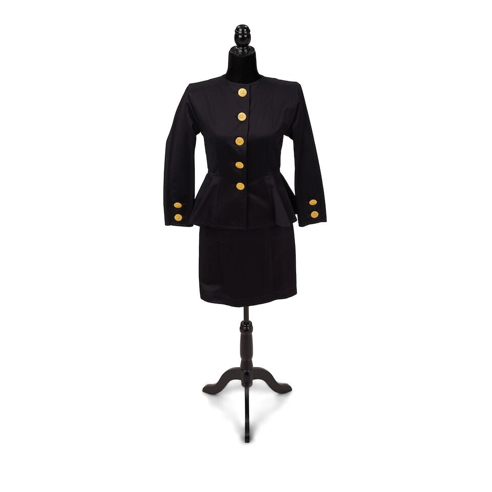 AN YVES SAINT LAURENT BLACK SKIRT SUIT Yves Saint Laurent, 1991: AN YVES SAINT LAURENT BLACK SKIRT SUIT Yves Saint Laurent, 1991 Cotton, with gold-tone metal button details, 38. This lot is subject to the following lot symbols: ¤ ¤ Unless indicated by the