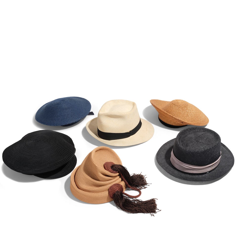 A GROUP OF VINTAGE STRAW HATS: A GROUP OF VINTAGE STRAW HATS Comprising an off-white fedora with a black bow, a tan beret with black velvet trim, a navy blue sailor beret with navy blue ribbon, a dark gray fedora with a taupe and