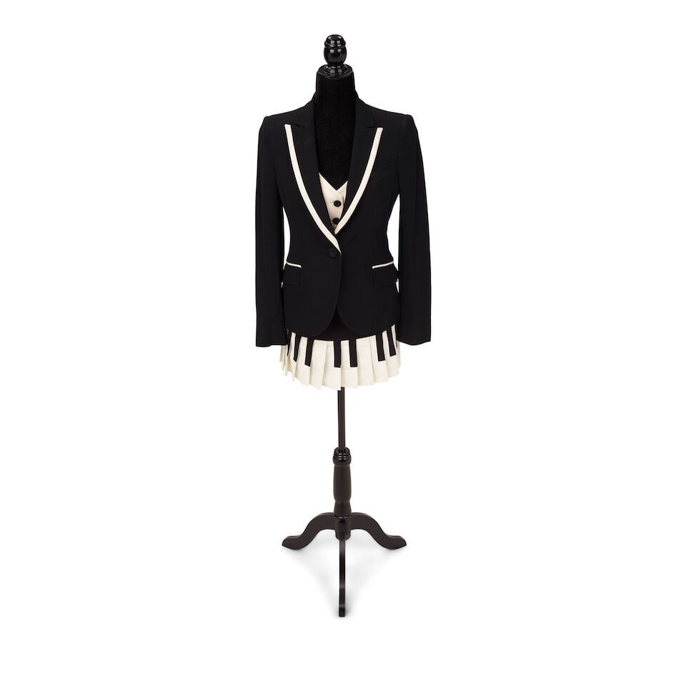 A MOSCHINO CHEAP & CHIC BLACK AND WHITE TWO-PIECE 'PIANO KEY' SKIRT SUIT WORN AT THE GRAMMY'S Fr...: A MOSCHINO CHEAP & CHIC BLACK AND WHITE TWO-PIECE 'PIANO KEY' SKIRT SUIT WORN AT THE GRAMMY'S Franco Moschino, Spring/Summer 1993 Comprising a black jacket with white trim with built-in white vest