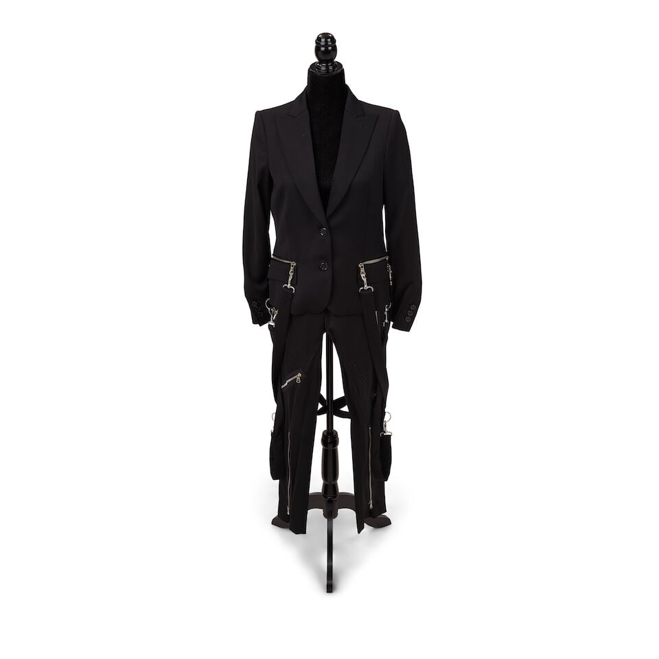 THREE MOSCHINO PUNK LOOKS 2013-2022: THREE MOSCHINO PUNK LOOKS 2013-2022 Comprising a black double-breasted halter blazer dress, 8, a Cheap & Chic plaid and leather blazer, 10 and a Moschino Couture! black pant suit with hardware