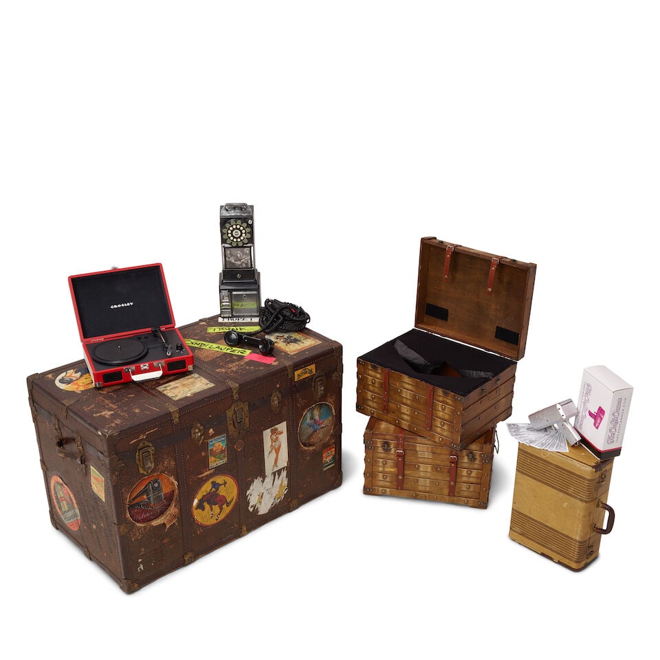 A GROUP OF STAGE PROPS FROM THE DETOUR TOUR 2016: A GROUP OF STAGE PROPS FROM THE DETOUR TOUR 2016 Comprising a trunk with travel stickers and various inscriptions, a small vintage suitcase, a Crosley red briefcase record player with a piece of tape 
