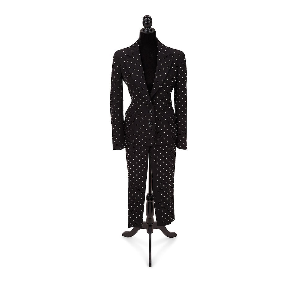 TWO MOSCHINO PANT SUITS 2010s-2020s: TWO MOSCHINO PANT SUITS 2010s-2020s Comprising a Moschino Cheap & Chic black studded blazer and trousers and a Moschino Couture! red cutout blazer and trousers. Footnotes: The black studded suit worn 