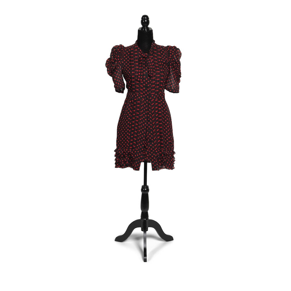 THE DRESS AND WIG WORN ON THE MEMPHIS BLUES ALBUM COVER 2010: THE DRESS AND WIG WORN ON THE MEMPHIS BLUES ALBUM COVER 2010 Comprising a Phi black and red polka dot silk dress and skirt, 6, 8, and a curly blonde wig, together with a black leather asymmetrical