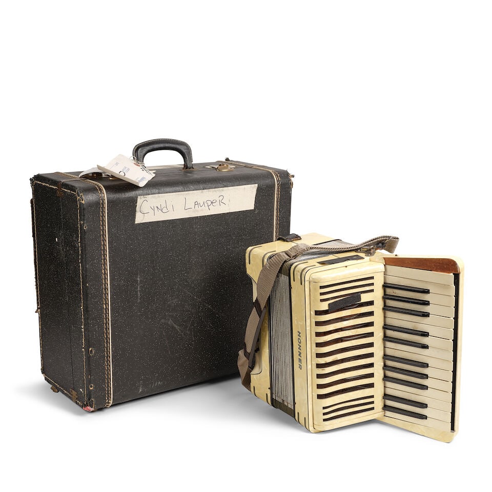 A VINTAGE HOHNER ACCORDION Germany, 20th century: A VINTAGE HOHNER ACCORDION Germany, 20th century Stamped II / MADE BY M HOHNER / GERMANY, together with a carrying case with road tape and tags from Studio Instrument Rentals, inscribed Cyndi Lauper,