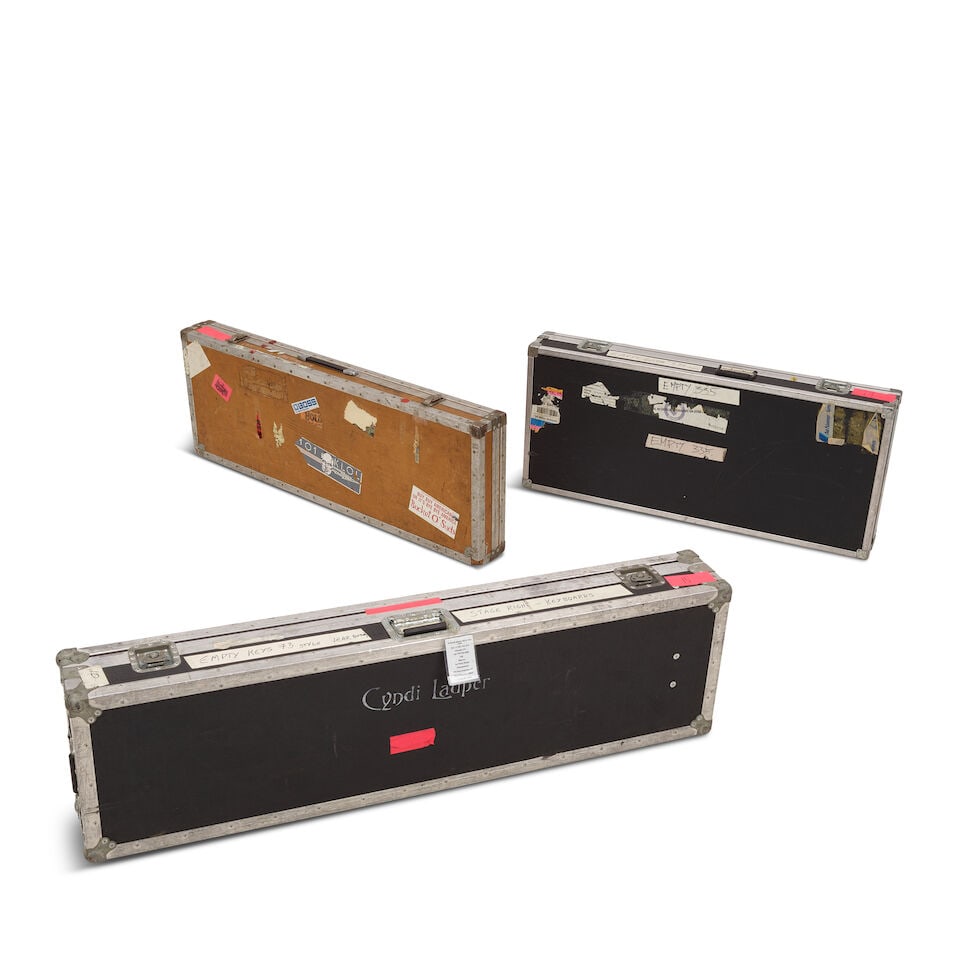 THREE TOUR-USED CYNDI LAUPER STENCILED ROAD CASES One dated 1960: THREE TOUR-USED CYNDI LAUPER STENCILED ROAD CASES One dated 1960 Two for a guitar and one for a keyboard, all empty and with various inscriptions, stickers, and labels. the largest 8 x 61 x 17