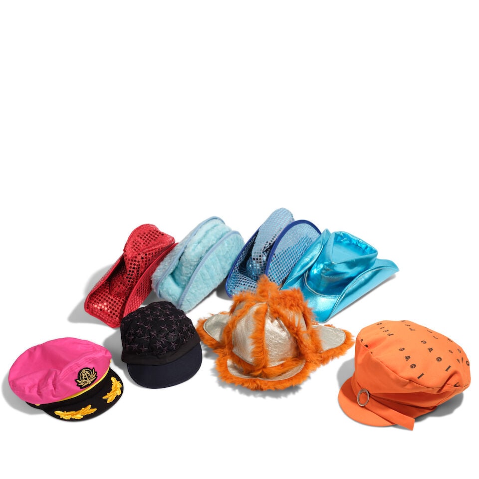 A GROUP OF NOVELTY HATS: A GROUP OF NOVELTY HATS Comprising a Marc Jacobs star embroidered cap, a Rub & Dub orange cap, an Exquisite J metallic and orange faux fur trapper hat, a Broner adjustable hot pink captain's hat,