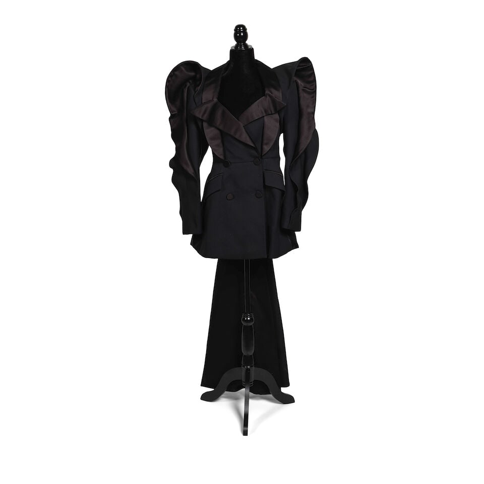 TWO ALEXANDER MCQUEEN JACKETS 2012 & 2020: TWO ALEXANDER MCQUEEN JACKETS 2012 & 2020 Comprising a 2012 black coat, 44, and a 2020 black ruffle detail tailcoat, 40. Footnotes: The 2012 black coat worn to the Kinky Boots Broadway Opening Night
